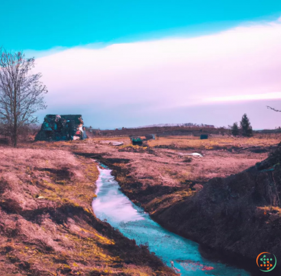 A stream of water with a tractor and a house in the background