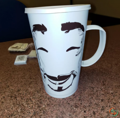 A coffee mug with a face drawn on it