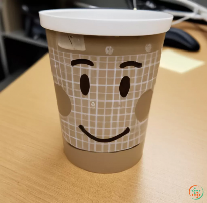 A coffee cup with a face on it