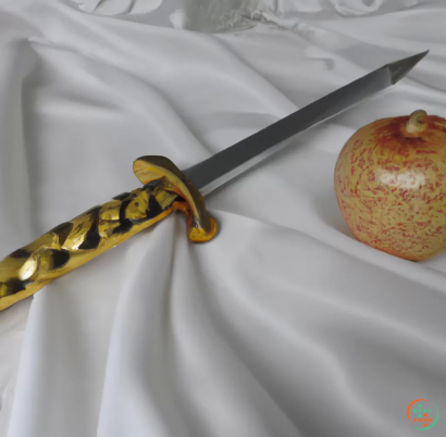 A knife next to an apple