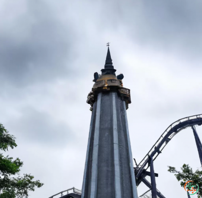 A tall tower with a cross on top