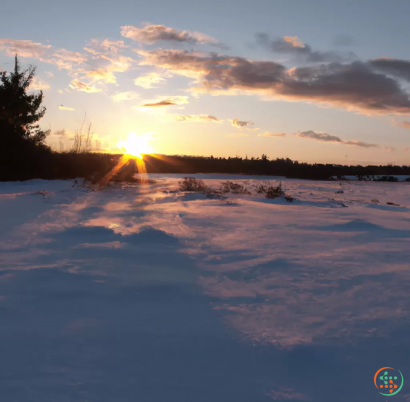 A sunset over a snowy field
