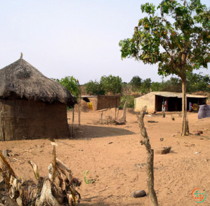 A group of huts in a dirt area