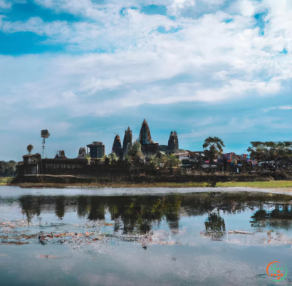 A body of water with Angkor Wat in the background