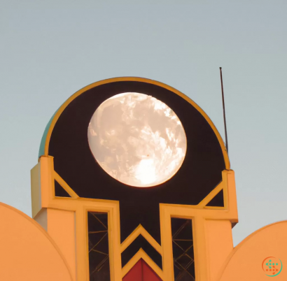 A large round building with a large moon on top