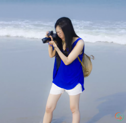 A woman holding a camera on a beach