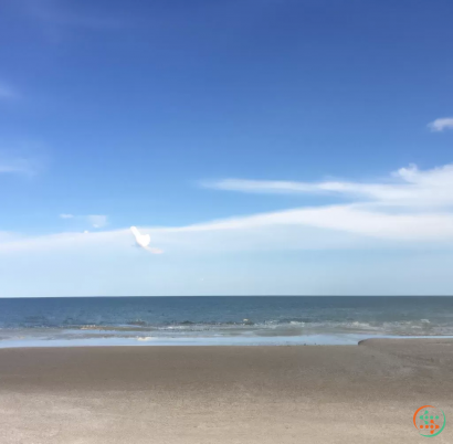 A beach with a body of water in the background