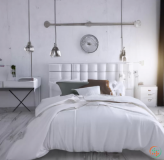 A bed with a white bed and a white wall with a clock
