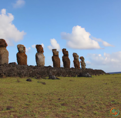 A group of rocks stacked on top of each other with Easter Island in the background