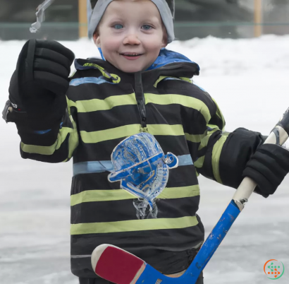 A young boy holding a hockey stick