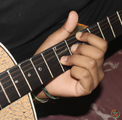 A person's hand holding a guitar