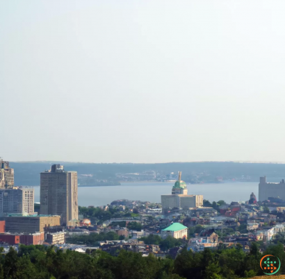 A city with a body of water in the background