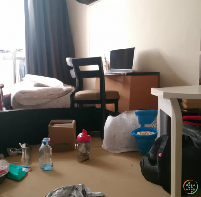 A room with a desk and a chair and a laptop