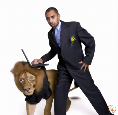 A man in a suit and tie holding a laptop and a lion