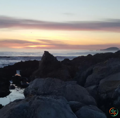 A rocky beach with a sunset