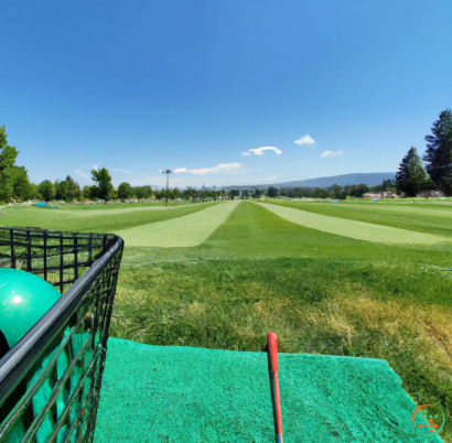 A golf course with a green field