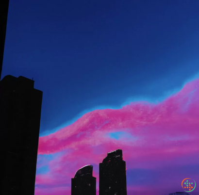 A group of buildings with a pink and blue sky