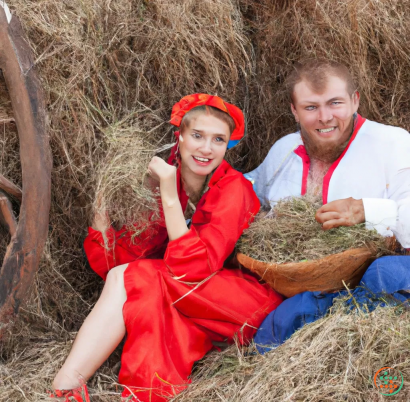 A man and woman holding a large turkey