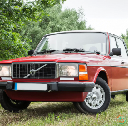 A red truck parked in a grassy area