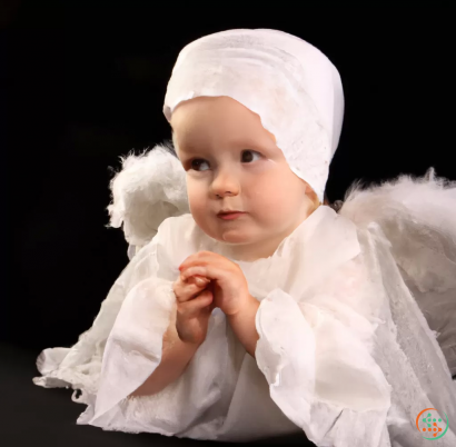 A baby wearing a white outfit