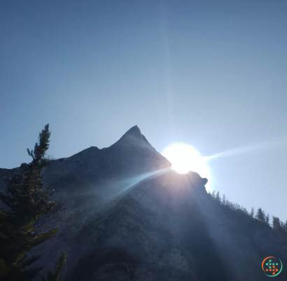 A mountain with the sun shining