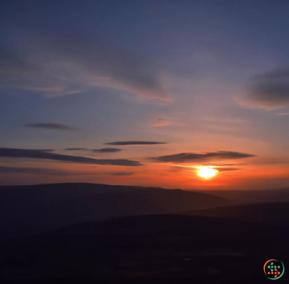 A sunset over a mountain