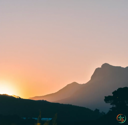 A sunset over a mountain