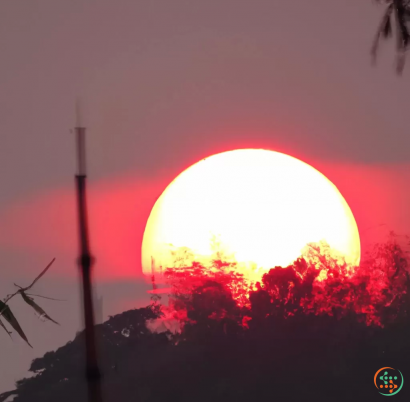 A bright sun over a hill