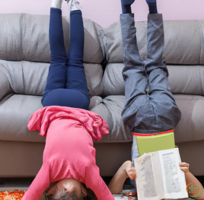 A person lying on the couch reading a book