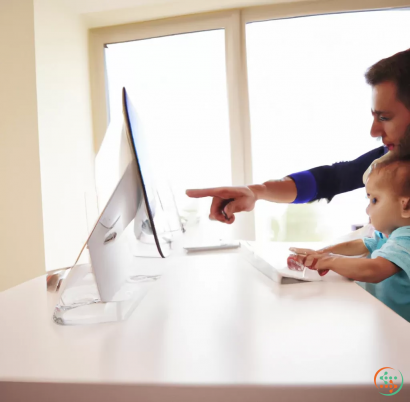 A person and a baby looking at a computer screen