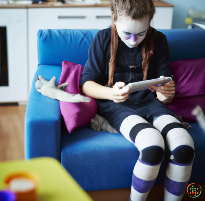 A girl sitting on a couch and using a tablet