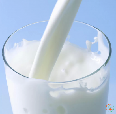 A glass of milk with a straw