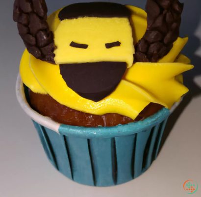A cupcake with a yellow and black character on top